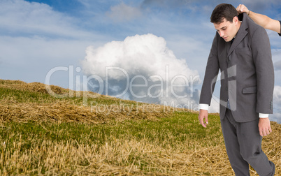 Composite image of businessman hanging