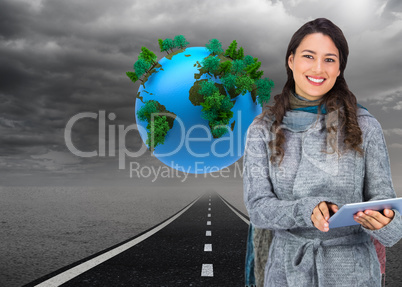 Composite image of smiling model wearing winter clothes holding