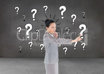 Composite image of thoughtful asian businesswoman pointing