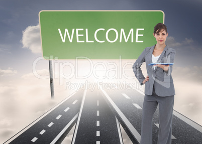 Composite image of attractive businesswoman holding tablet pc