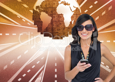 Composite image of happy brunette holding smartphone