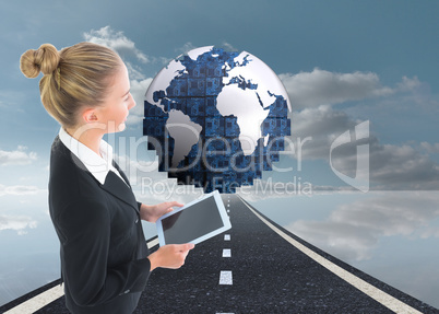 Composite image of businesswoman holding tablet