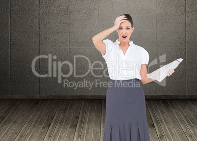 Composite image of shocked classy businesswoman holding newspape