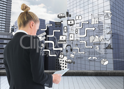 Composite image of businesswoman holding tablet