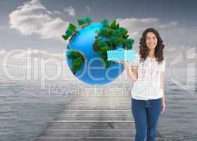 Composite image of content casual brunette holding a present