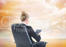 Composite image of businesswoman sitting on swivel chair with ta