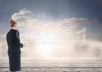 Composite image of businesswoman holding new tablet