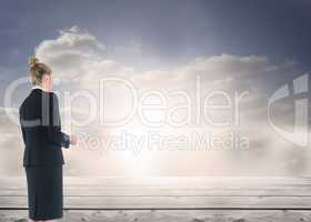 Composite image of businesswoman holding new tablet