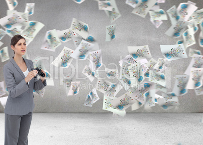 Composite image of curious young businesswoman with binoculars