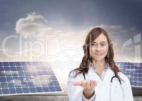 Composite image of portrait of female nurse holding out open pal