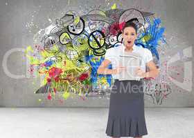 Composite image of shocked stylish businesswoman holding newspap