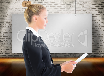 Composite image of businesswoman holding tablet