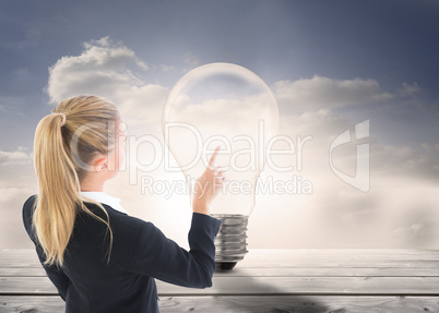 Composite image of businesswoman pointing somewhere