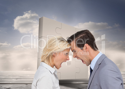 Composite image of colleagues quarreling head against head