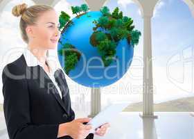 Composite image of businesswoman holding tablet