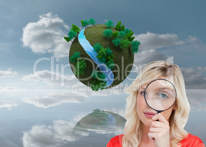 Composite image of fair-haired woman looking through a magnifyin