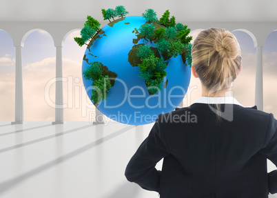 Composite image of businesswoman standing with hands on hips