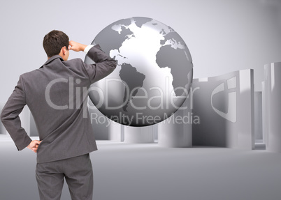 Composite image of businessman standing hand on hip