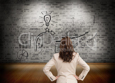 Composite image of businesswoman standing back to camera