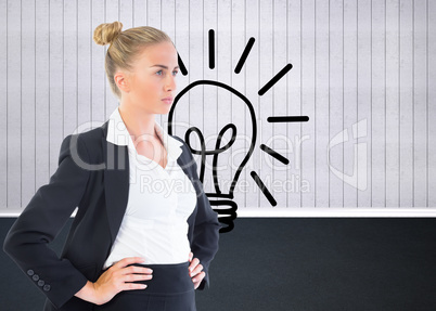 Composite image of businesswoman standing with hands on hips