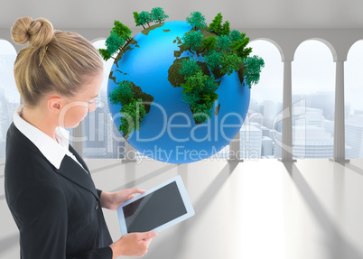 Composite image of businesswoman holding tablet