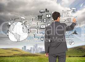 Composite image of businessman standing back to camera writing w