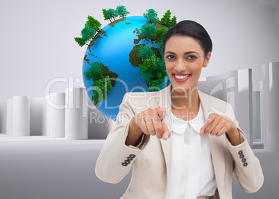 Composite image of smiling businesswoman pointing at the camera