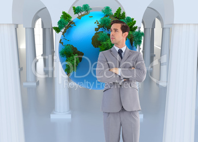 Composite image of serious businessman with arms crossed