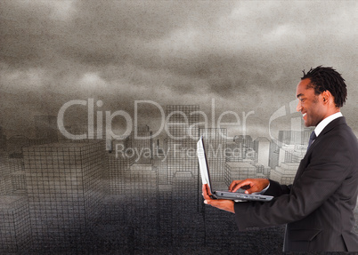 Composite image of businessman working on laptop