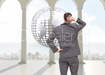 Composite image of young businessman standing back to camera scr