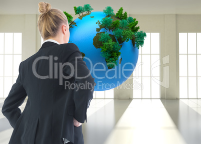 Composite image of businesswoman standing with hands on hips