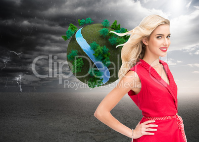 Composite image of smiling blonde standing hands on hips