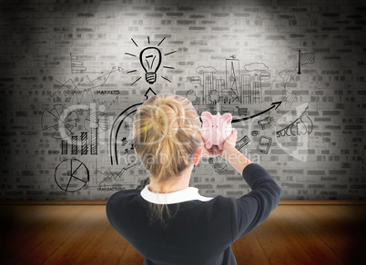 Composite image of businesswoman holding pink piggy bank