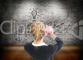 Composite image of businesswoman holding pink piggy bank