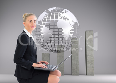 Composite image of businesswoman using laptop