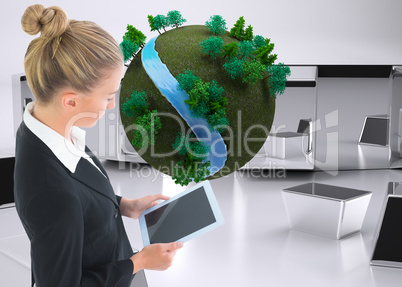 Composite image of businesswoman holding tablet