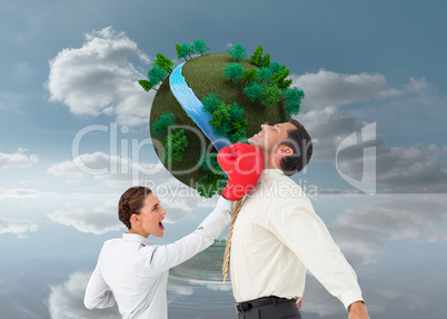 Composite image of businesswoman hitting a businessman with boxi