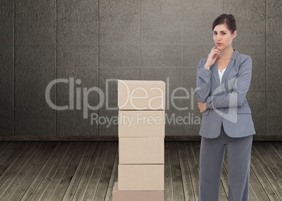 Composite image of thoughtful businesswoman posing with cardboar