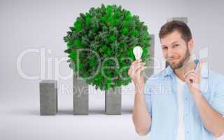 Composite image of charming model holding a bulb in right hand