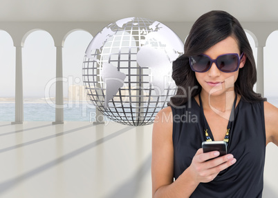 Composite image of happy brunette using smartphone