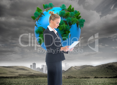 Composite image of businesswoman holding new tablet