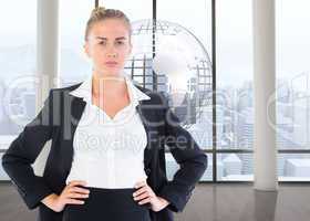 Composite image of businesswoman standing with hands on hips