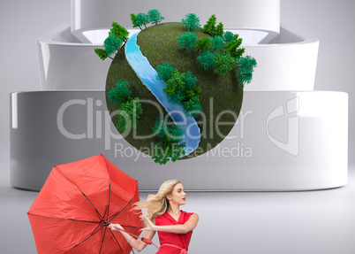 Composite image of beautiful woman posing with a broken umbrella