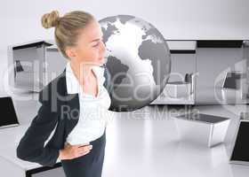 Composite image of businesswoman standing with hands on hips