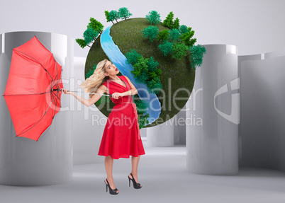 Composite image of elegant blonde holding umbrella