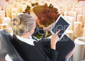 Composite image of businesswoman sitting on swivel chair with ta