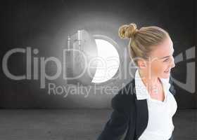 Composite image of businesswoman standing with hands on hips