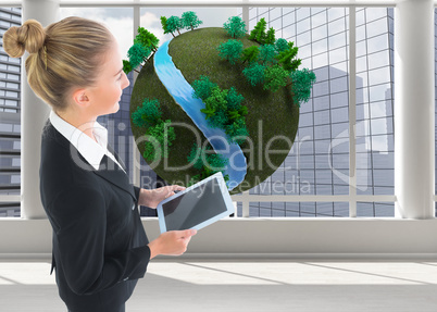 Composite image of businesswoman holding new tablet