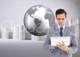 Composite image of businessman holding a tablet computer