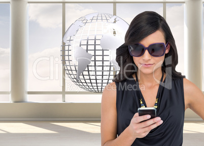 Composite image of happy brunette using smartphone